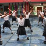 school-children-wearing-uniform-in-school-courtyard-doing-jumping-jacks